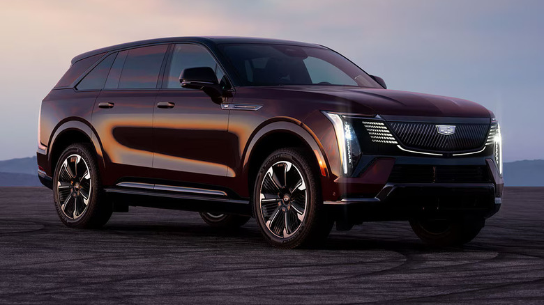 A purple 2026 Cadillac Escalade IQ with sunlight reflecting off its right passenger side.