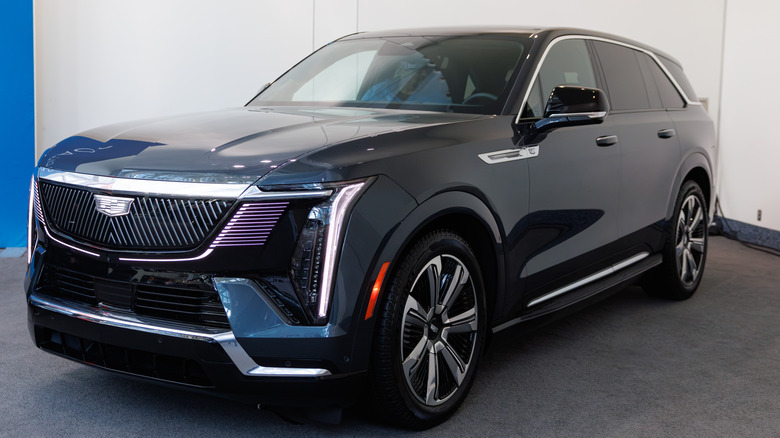 A black Cadillac Escalade IQ on display inside a dealership