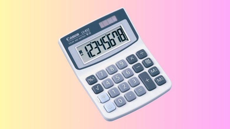Simple white Canon calculator showing numbers on the screen