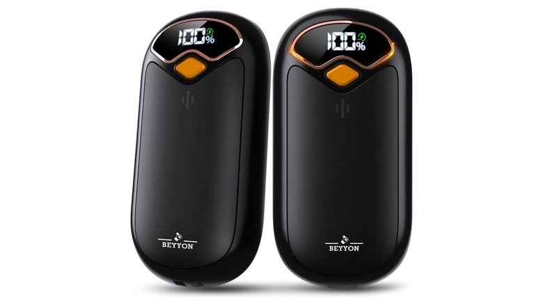 Stock photo of two black oval devices showing 100% on LED screens
