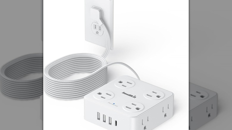 Stock photo of a white square power strip with multiple outlets on the top and sides