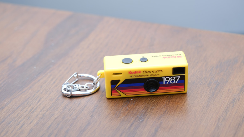 A Kodak Charmera keychain camera set on a wooden table