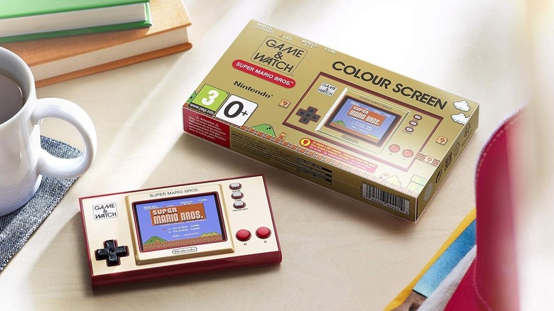 A Nintendo Game & Watch with its box on a desk