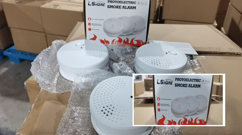 A bunch of smoke detector fire alarms out of a package.