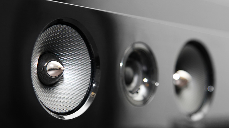 Close-up view of speaker drivers on a black soundbar.
