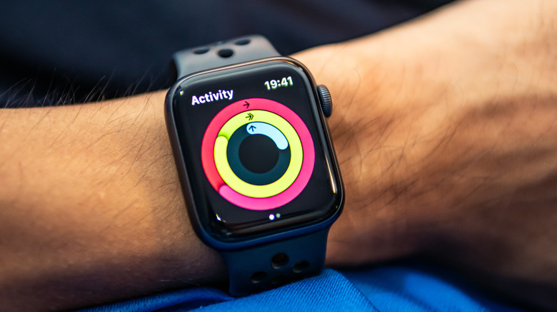 Apple Watch Series 4 worn on a wrist displaying fitness tracking activity rings.
