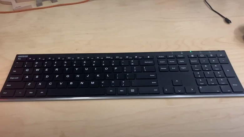A black Arteck wireless keyboard on a table