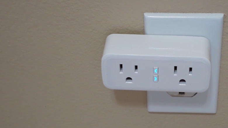A white GHome Smart Plug connected to a power outlet