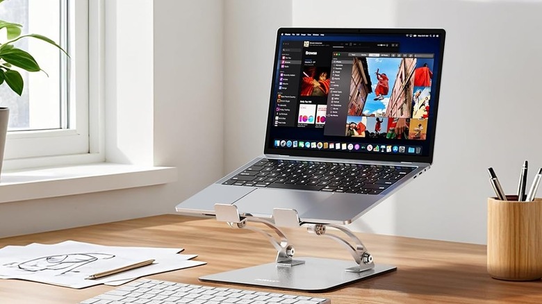 A Nulaxy laptop stand holding a notebook computer at an office table