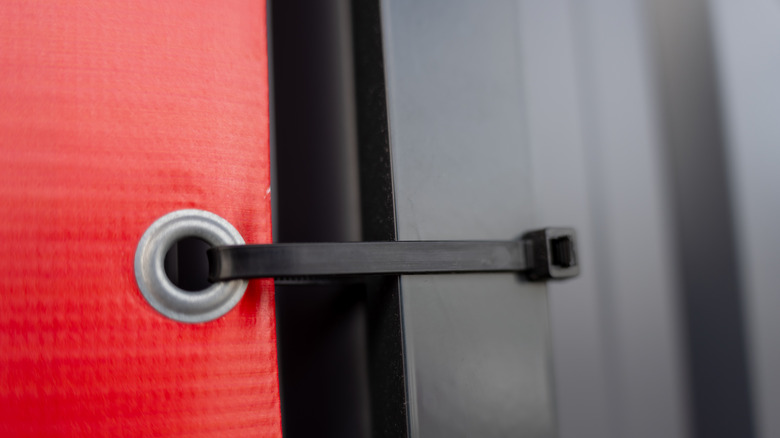Close up of a zip tie going through a grommet