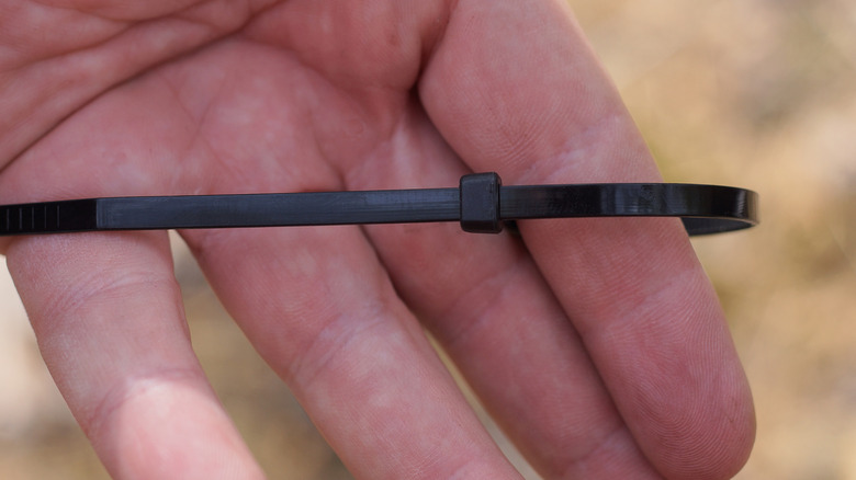 Zip tie on a person's hand