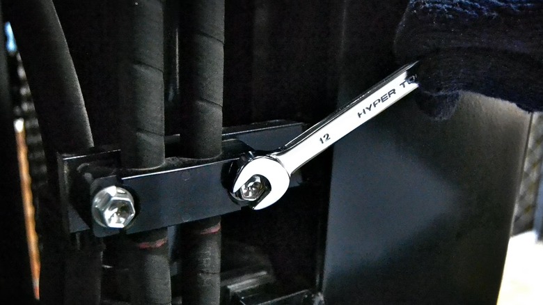 Person wearing work gloves turning bolt with Hyper Tough wrench