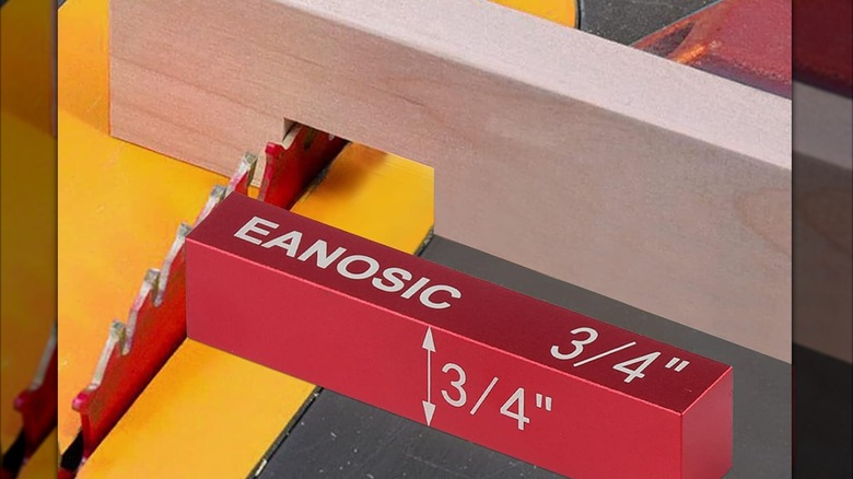 An Eanosic-branded setup block resting against the blade of a a table saw