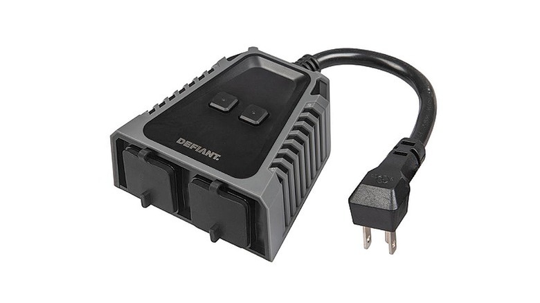 A Defiant outdoor smart plug set against a white background.