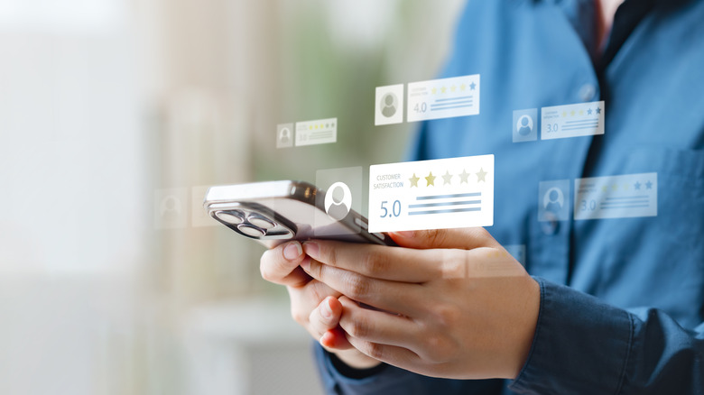 Holographic images of customer reviews around an iPhone