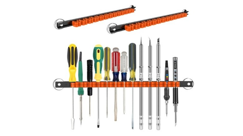Differently-sized screwdrivers placed on a horizontal rack
