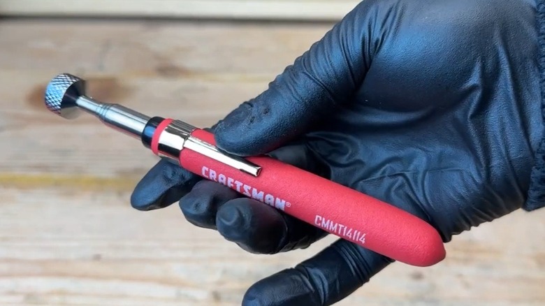 Person holding magnetic Craftsman retrieval tool