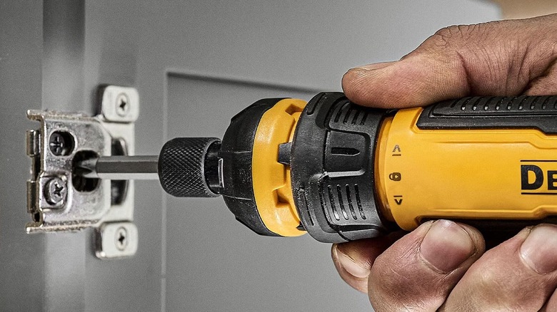 Person using DeWalt electric screwdriver