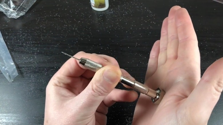 Person using miniature hand drill