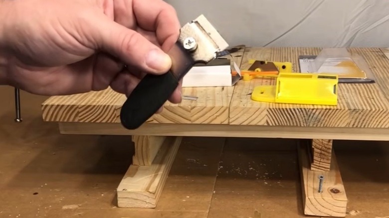 Person holding Harbor Freight razor blade scraper