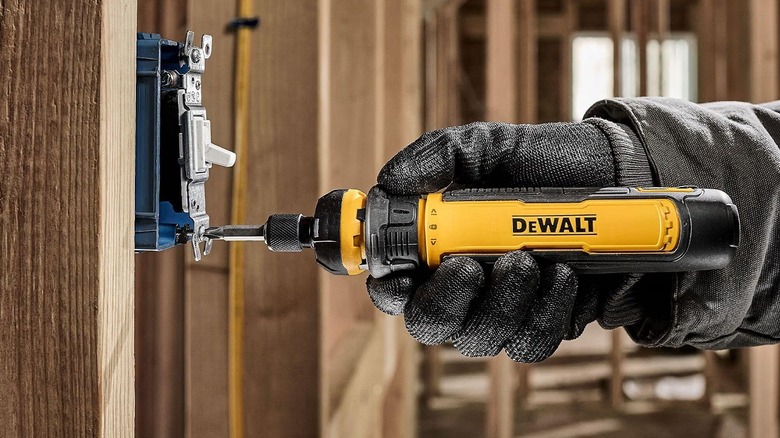 Person using DeWalt electric screwdriver