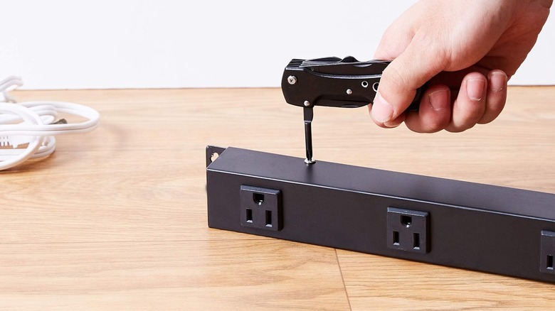 Person using Amazon Basics multitool
