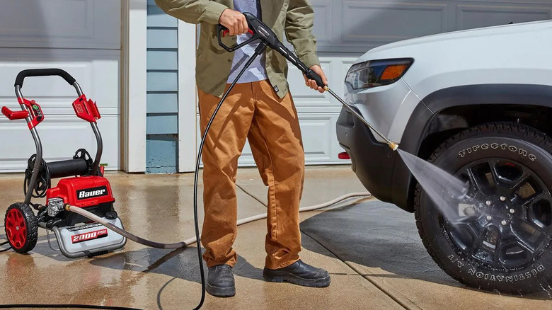 Using a 2000 PSI Bauer pressure washer to clean a car.