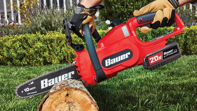 Bauer chainsaw cutting a log.