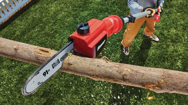 Closeup of the Bauer pole saw cutting a tree branch.