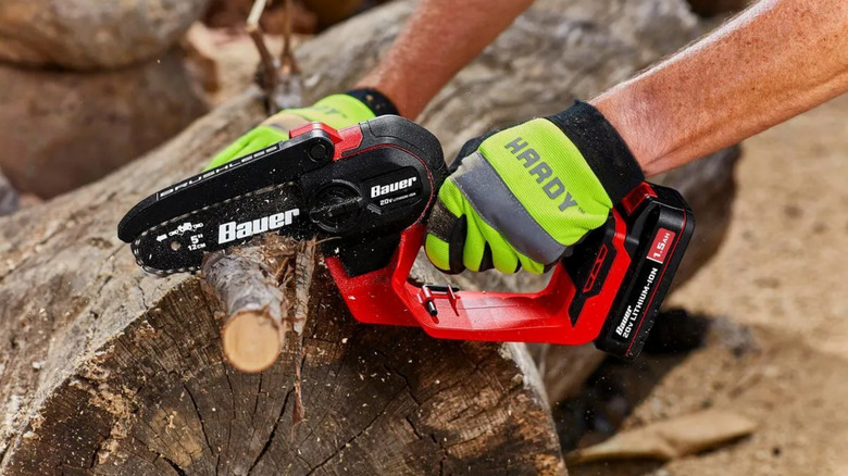 Bauer pruning saw cutting through a branch.