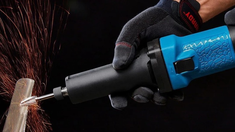 Grinding a metal part with a Hercules die grinder.