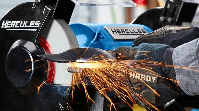 Grinding a metal part with the Hercules bench grinder.
