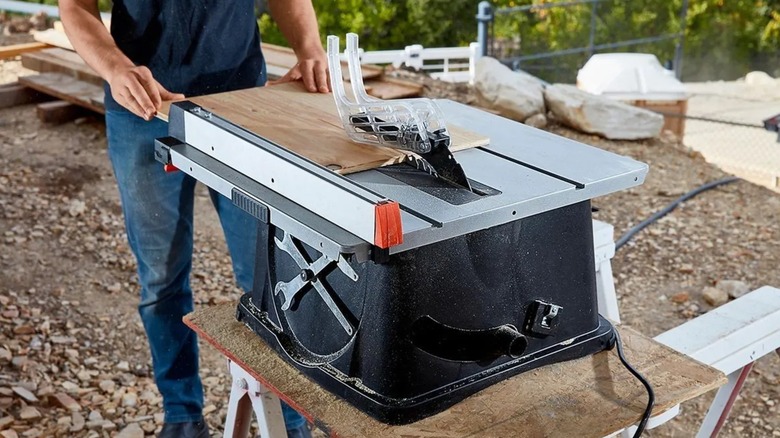 Cutting a board with a Warrior 10-inch table saw.