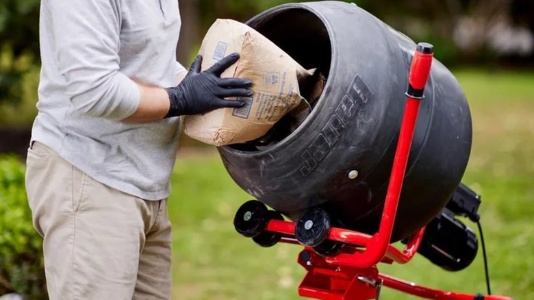 pouring concrete into cement mixer