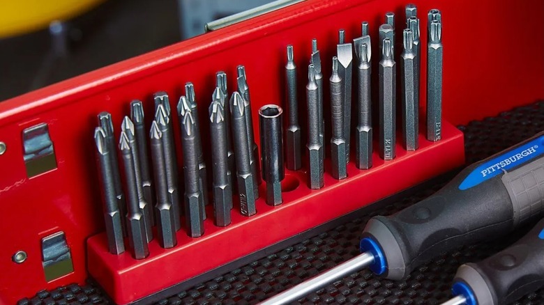 bit storage tool, filled with various screw bits, in a drawer of a toolbox