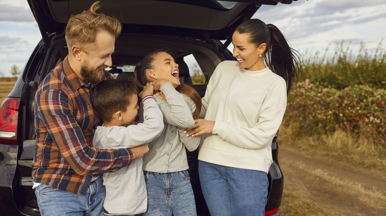 A family all smiles on a road trip