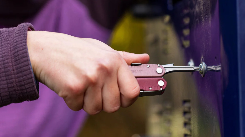 A person screwing with a Leatherman Multi-Tool