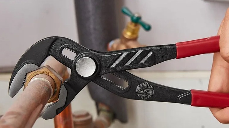 Using a water pump pllier on a water pipe.