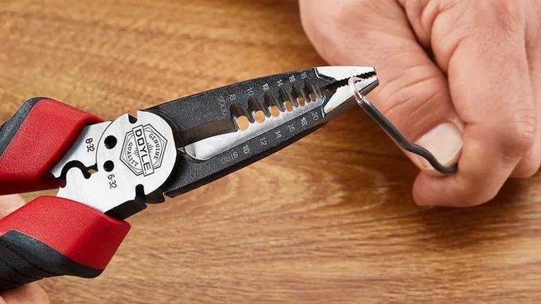 Using Doyle pliers to cut through wire.