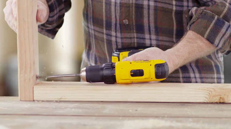 image of yellow DeWalt 20V Max cordless drill used on wood