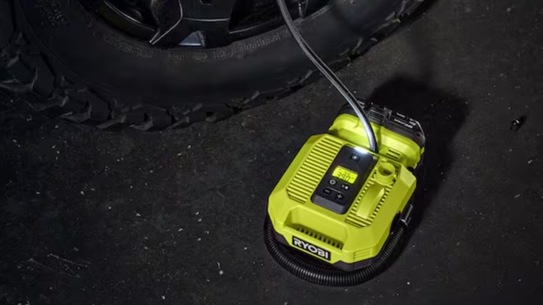 Ryobi One+ Inflator Kit inflating a car tire