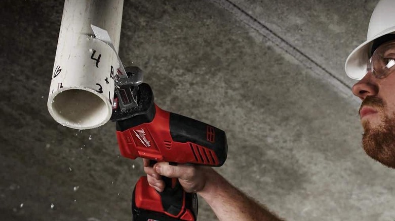 A saw cutting through pipe.