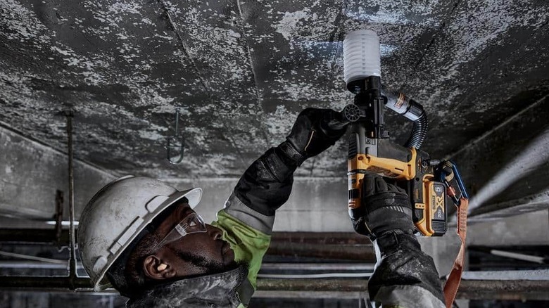 An hammer drill being used on a roof.