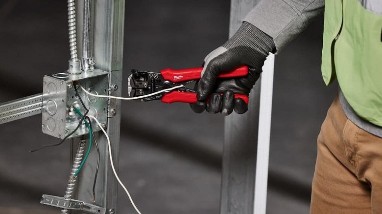 A wire stripper being used to strip a wire.