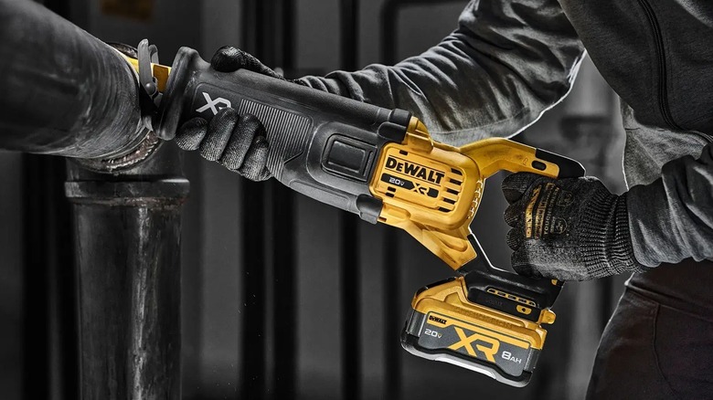Person using DeWalt reciprocating saw