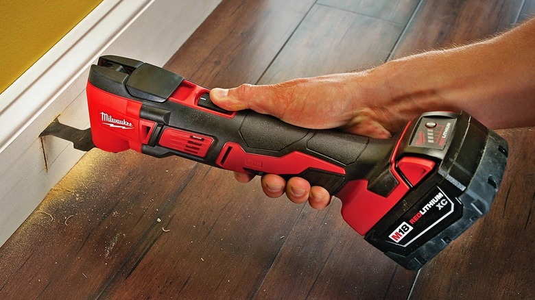 Person using Milwaukee multi-tool