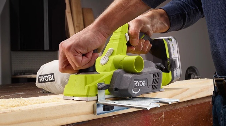 Person using Ryobi cordless planer