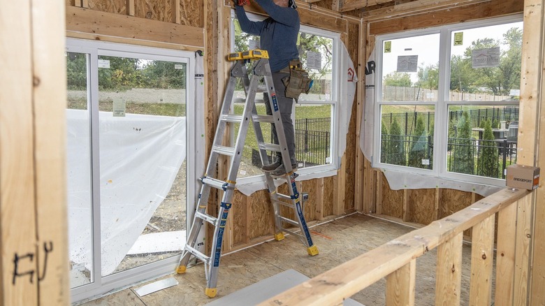 Person using Werner multi-position ladder