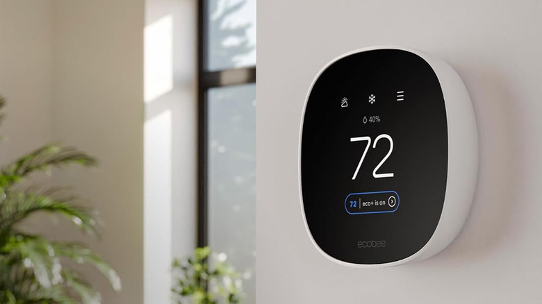 An Ecobee Essential Smart Thermostat hung on a white wall