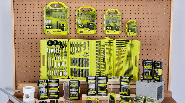 Several Ryobi drill bit kits hung or displayed near one another